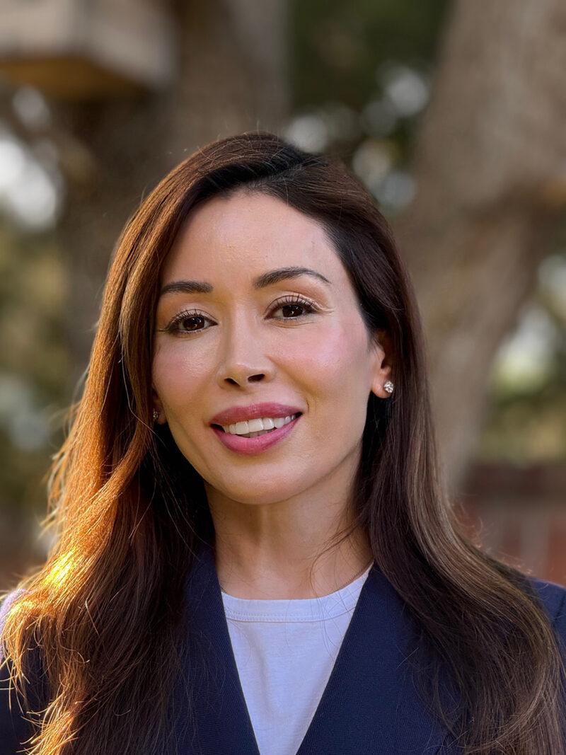 Izabella Miller, telehealth counselor in Texas, smiling outdoors